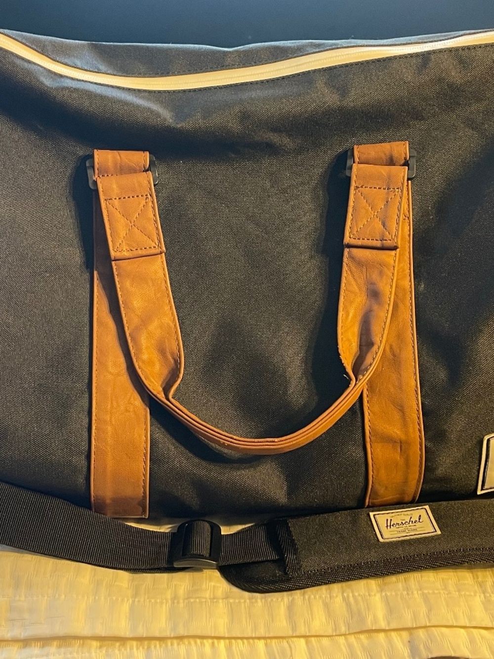 Black Herschel Duffle bag with brown leather straps